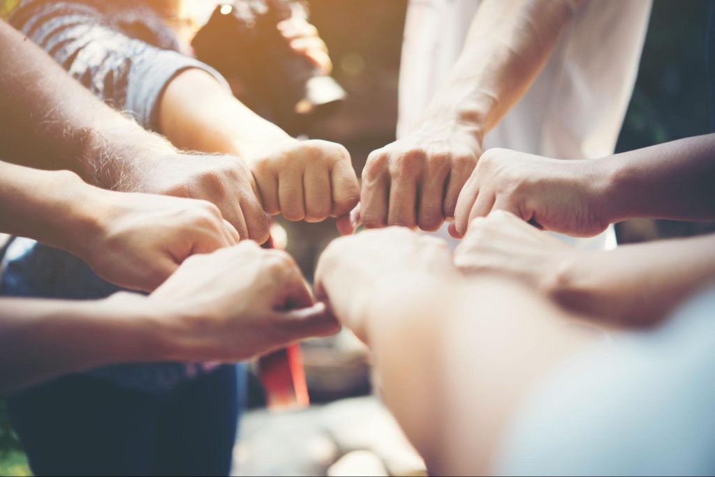 people’s hand in circle showing a strong community