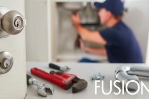 A close-up artistic view of modern door hardware and sleek architectural lines, featuring the Fusion logo for a contemporary property management theme.